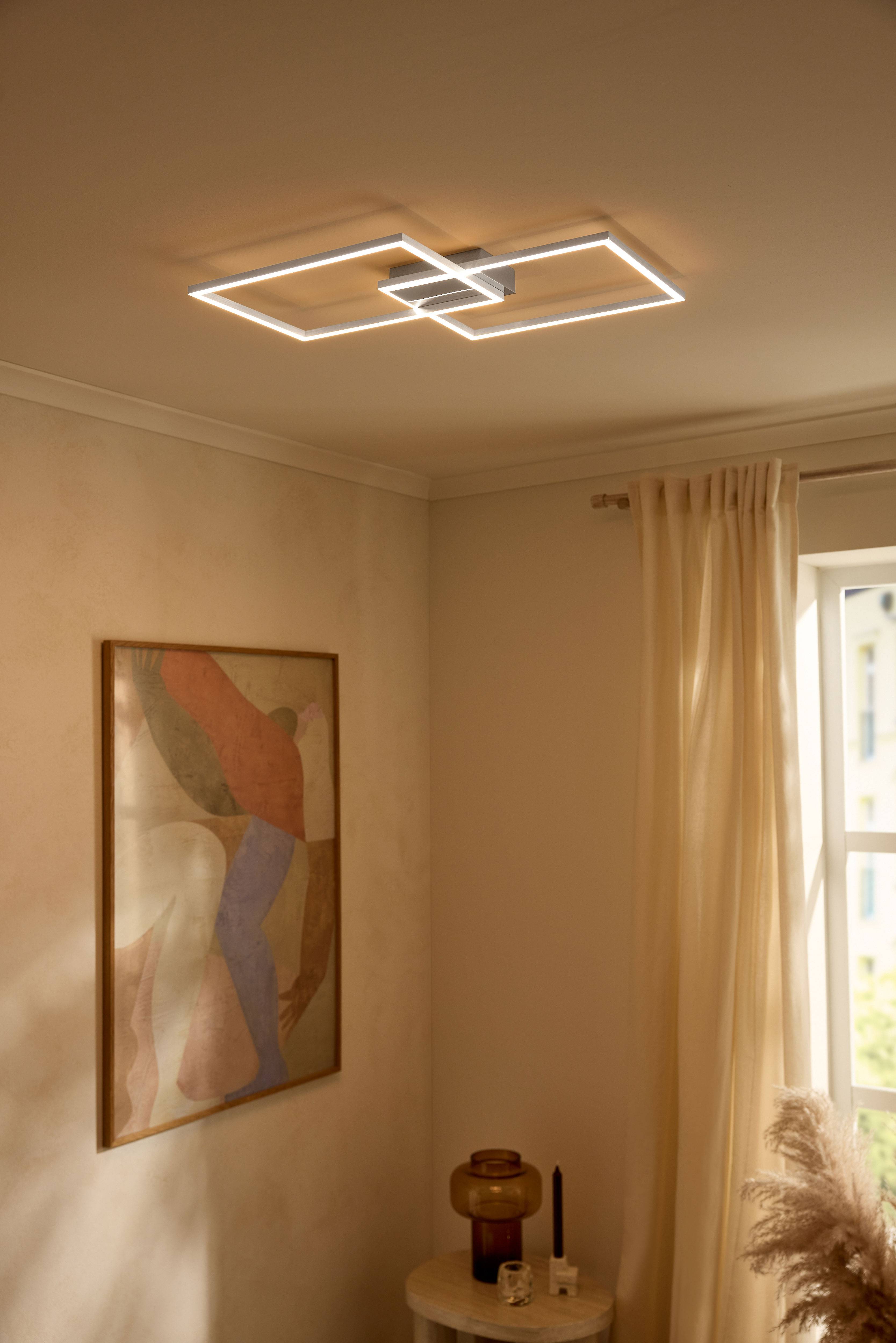 Moderni LED-kattovalaisin suorakulmaisilla muodoilla valaisemassa beigenväristä huonetta.