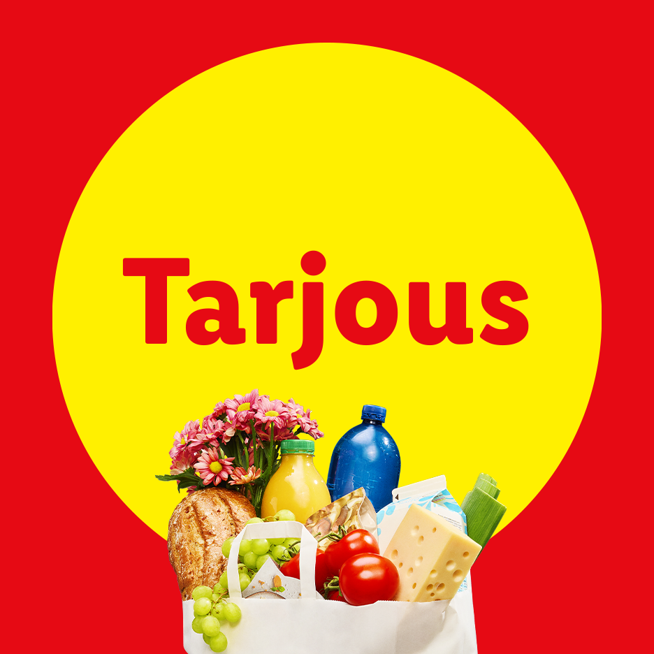 Ostoskassi täynnä ruokaa ja kukkia, teksti 'Tarjous' keltaisessa ympyrässä.